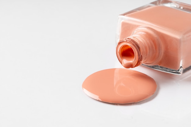 Photo puddle of spilled nail lacquer on a white surface