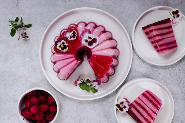 Puding buah naga Layered pudding made from dragon fruit and milk garnish with edible flowers