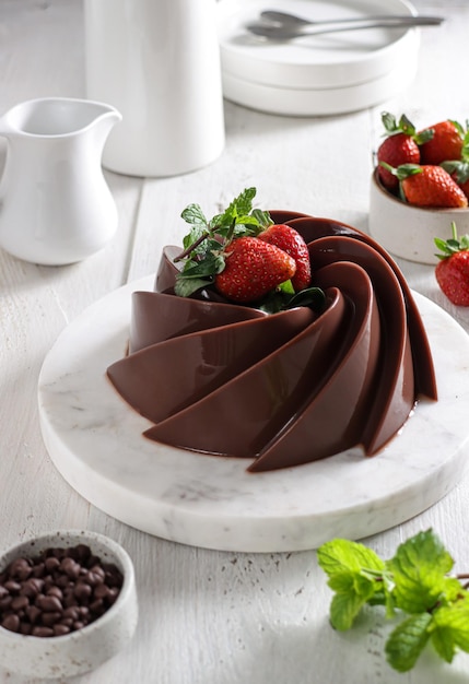 Puding Coklat or Chocolate Pudding is a dessert with chocolate flavors topping with strawberry