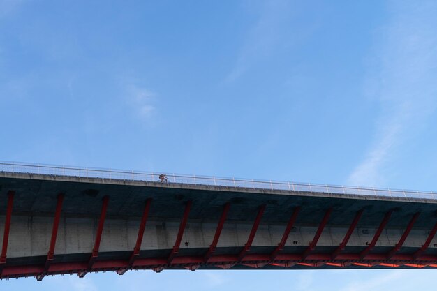 Photo puente de los santos with cyclist border of asturias and galicia spain view from below with sky background