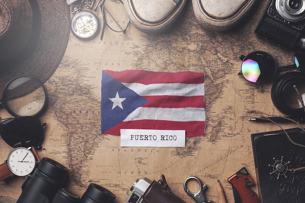 Puerto Rico Flag Between Traveler's Accessories on Old Vintage Map. Overhead Shot