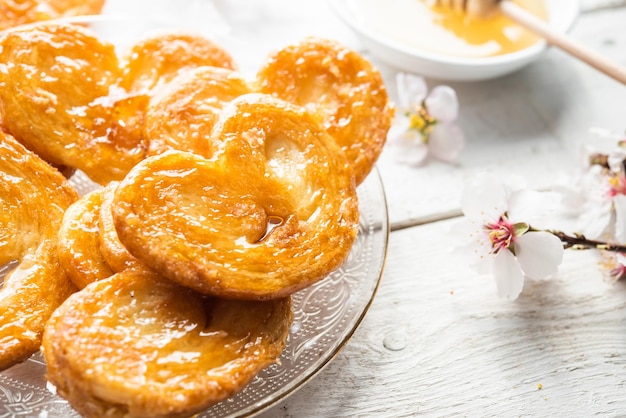 Puff pastry palms with honey dessert with flour sugar honey egg for breakfast industrial homemade