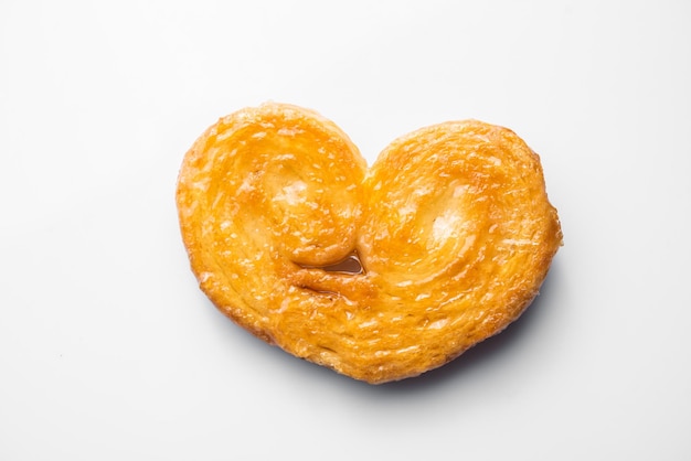 Puff pastry palms with honey pastries on a white background Dessert with flour sugar honey and egg