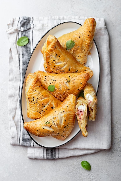 Photo puff pastry pies with cheese and ham