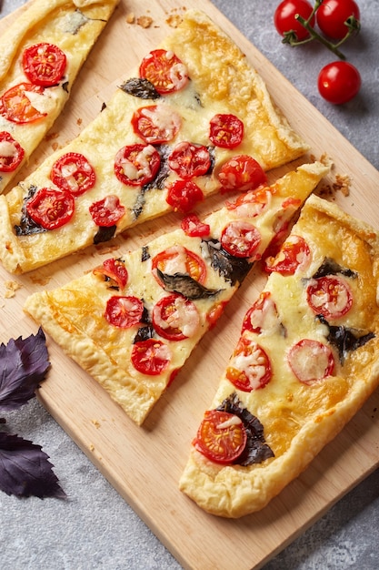 Puff pastry tart with cherry tomatoes mozzarella and purple basil