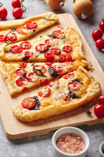 Puff pastry tart with cherry tomatoes mozzarella and purple basil