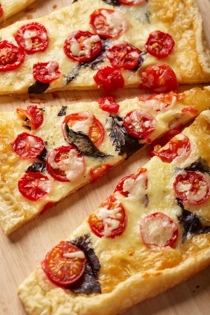 Puff pastry tart with cherry tomatoes mozzarella and purple basil