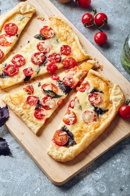 Puff pastry tart with cherry tomatoes mozzarella and purple basil