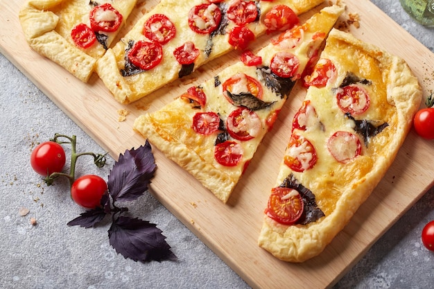 Puff pastry tart with cherry tomatoes mozzarella and purple basil