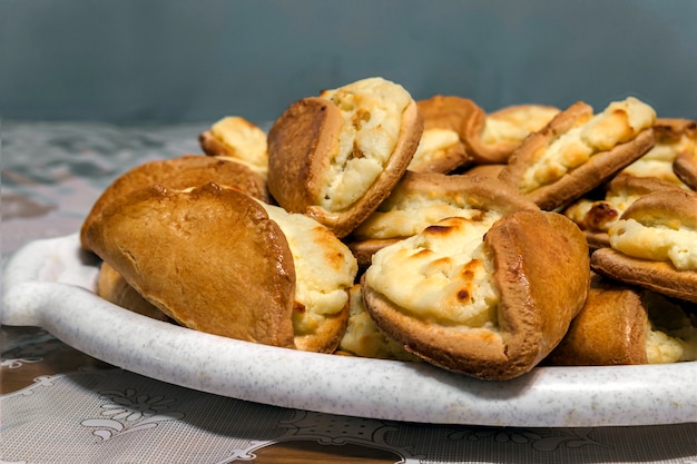 Puff pastry with cheese on a wooden background. Homemade baking