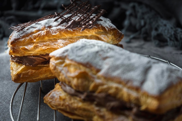 Puff pastry with confectioners sugar and chocolate filling