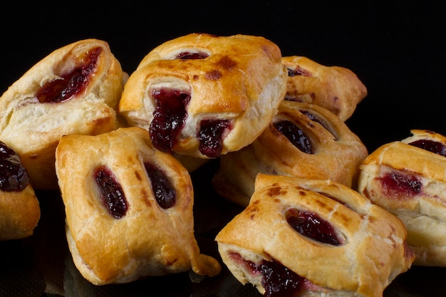 Puff pastry with jam closeup on a dark background