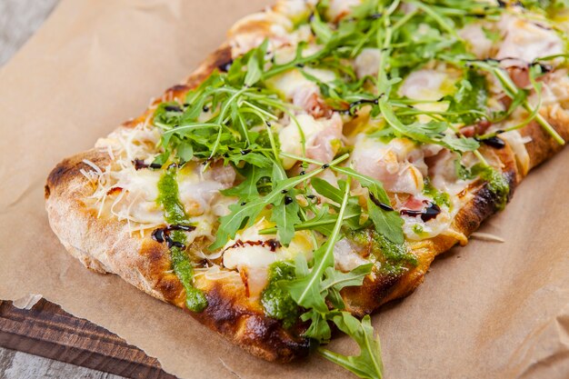 Puffed pies with bacon cheese and arugula with pesto sauce