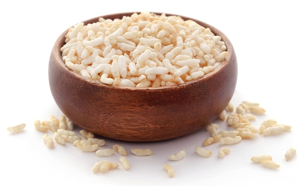 Puffed rice in a bowl over white background