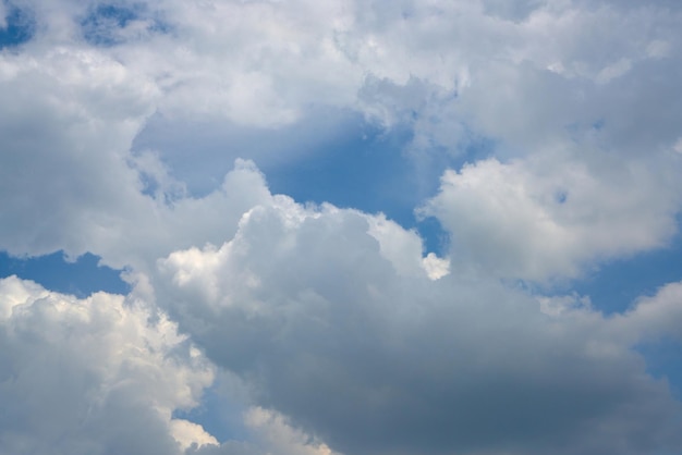 Puffy white clouds in a blue sky.