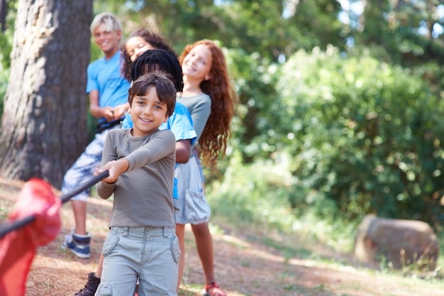 Pull Children playing at tugofwar in the woods