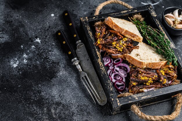 Pulled pork Sandwich with smoked pork meat in a wooden tray