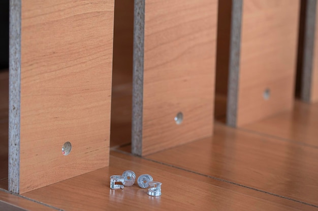 Photo pulling together pieces of furniture with an eccentric and a chrome barrel closeup fixing furniture