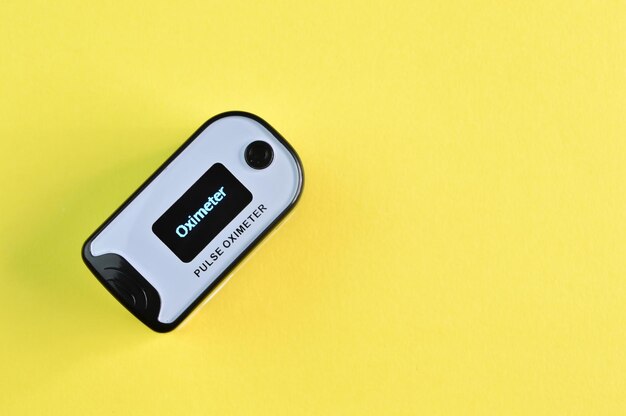 Pulse oximeter isolated on a yellow background