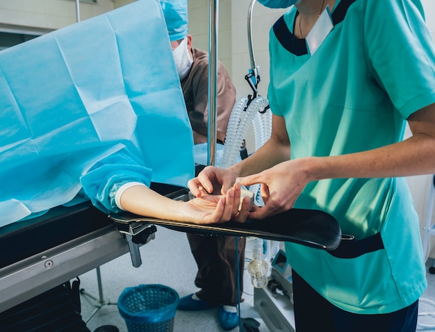 Pulse oximeter on the patient's hand