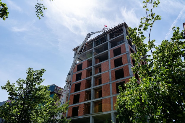 The pump delivers concrete to the roof of a highrise building under construction