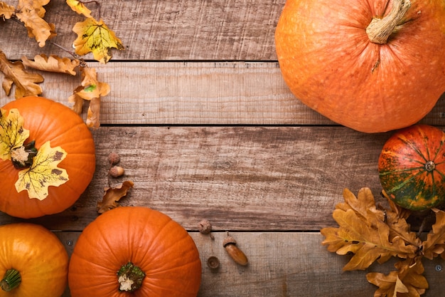 Pumpkin. Autumn food background with cinnamon, nuts and seasonal spices on rustic background. Cooking pumpkin or apple pie and cookies for Thanksgiving and autumn holidays. Top view with copy space.