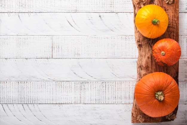 Pumpkin Autumn food background with cinnamon nuts and seasonal spices on rustic background Cooking pumpkin or apple pie and cookies for Thanksgiving and autumn holidays Top view with copy space