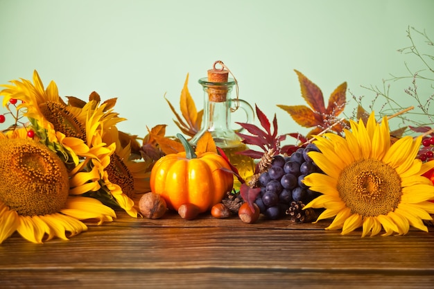 Pumpkin, autumn leaves, grape, sunflower, candle and berries