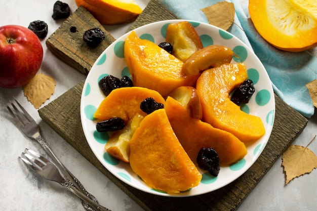 Pumpkin baked with apples in a bowl