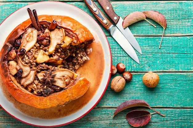 Pumpkin baked with granola and dried fruits.Autumn dessert.American food