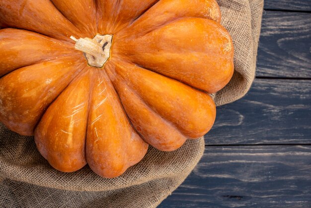 Pumpkin on a black wooden background still life for halloween or thanksgiving