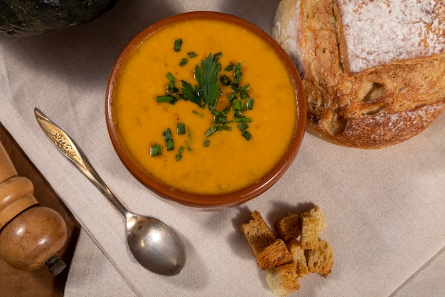 Pumpkin broth on wooden background.