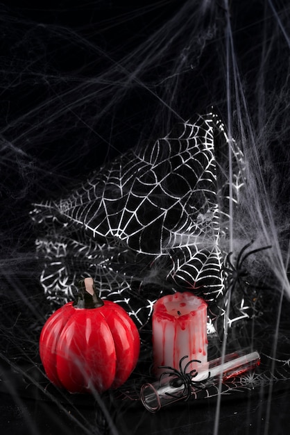 Photo pumpkin, candle and a long glass with a red cocktail