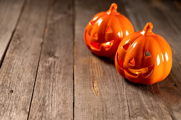 Pumpkin candlestick on rustic wooden table with copy space