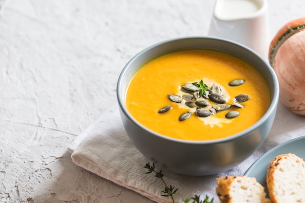 Pumpkin and carrot cream soup with seeds