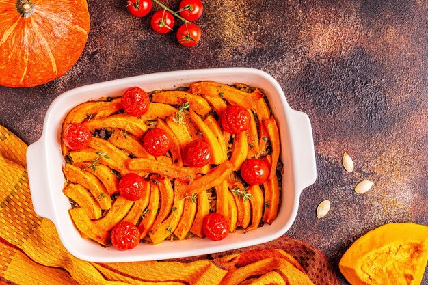 Pumpkin casserole with meat, rice, tomatoes, top view.