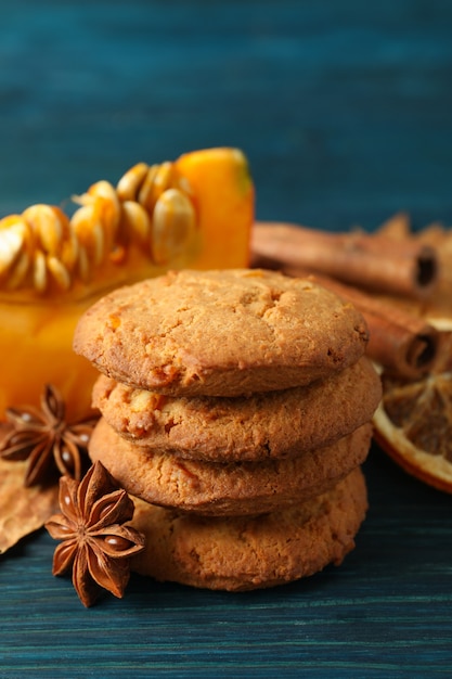 Pumpkin cookies on blue wooden background, close up.