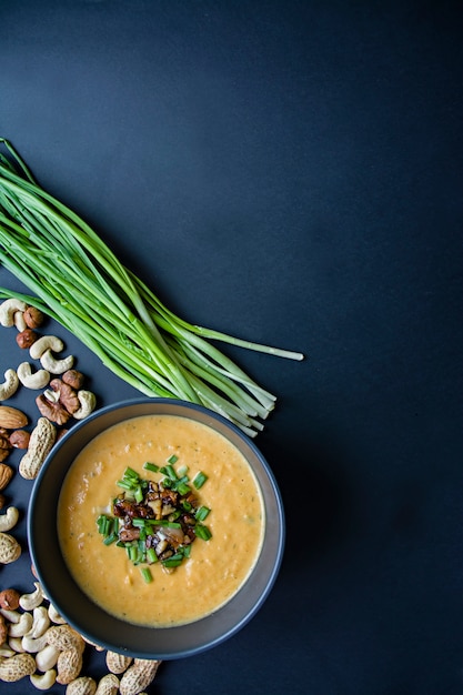 Pumpkin cream soup. Dark background.