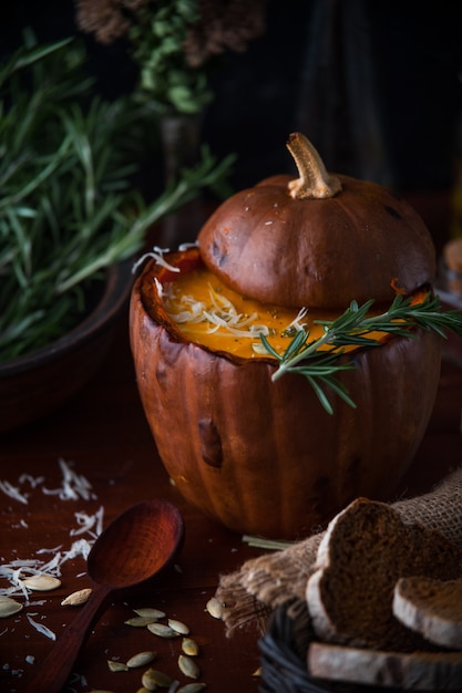 Pumpkin cream soup rustic style on dark background