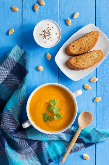 Pumpkin cream soup with bread and parsley