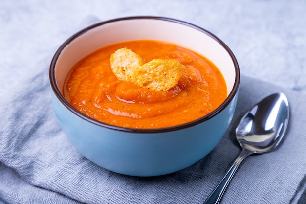 Pumpkin cream soup with croutons in a bowl