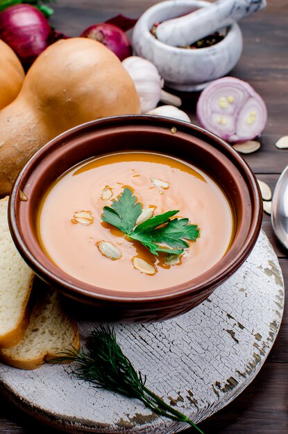 Pumpkin cream soup with pumpkin seeds  in bowl 