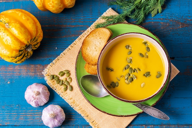 Pumpkin cream soup with pumpkin seeds served in a bowl