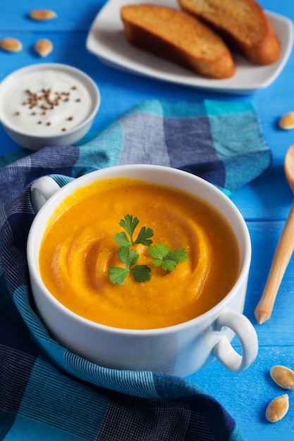 Pumpkin cream soup with seeds and parsley