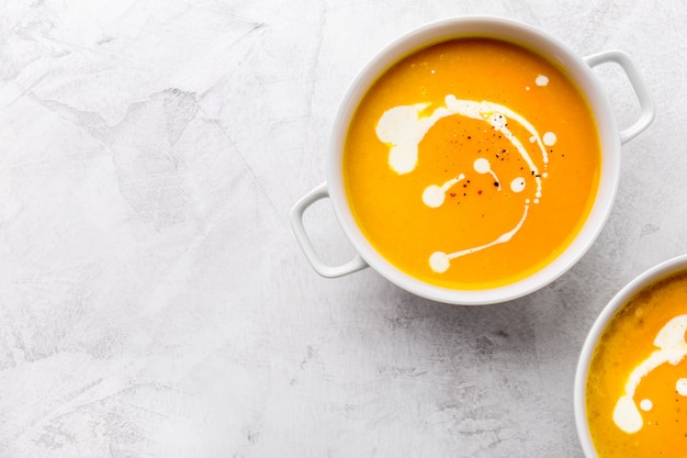 Pumpkin creamy soup decorated with fresh cream