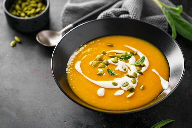 Pumpkin creamy soup served in bowl