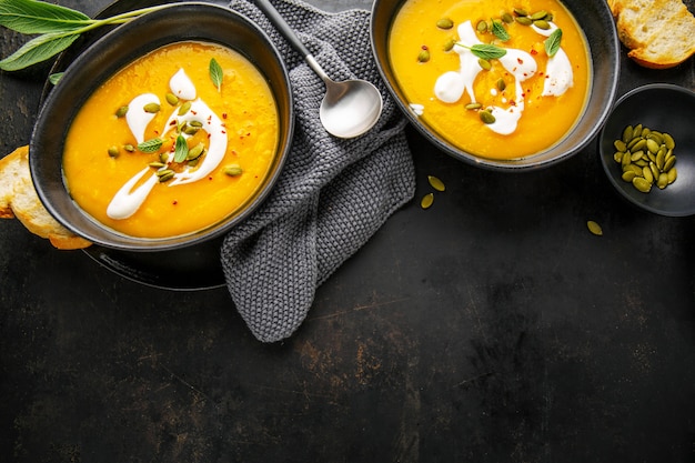 Pumpkin creamy soup served in bowls