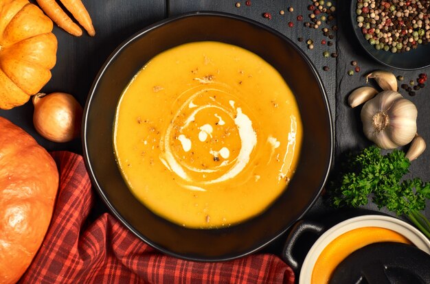 Pumpkin creme soup served with crushed nuts and cream