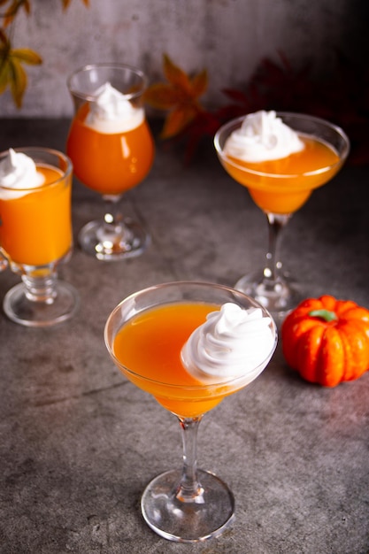 Pumpkin fall seasonal drink cocktail latte with spices and whipped cream for Thanksgiving or Halloween party festive celebrate Autumn decoration