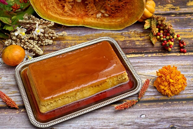 Pumpkin flan dessert made for the Day of the Dead Dessert on wooden table